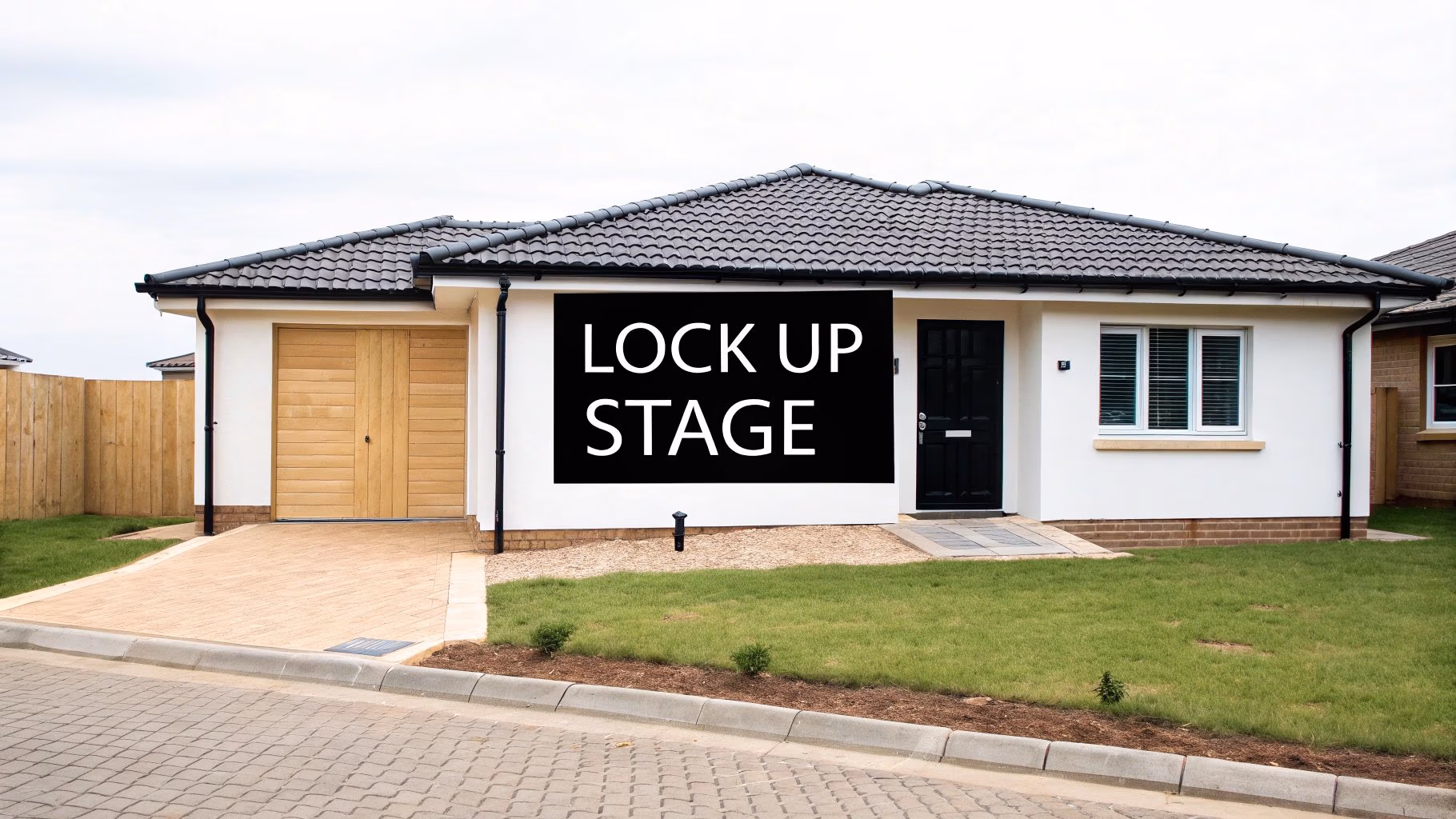 A new home under construction with the external walls, roof, and windows installed, representing the lock up stage.